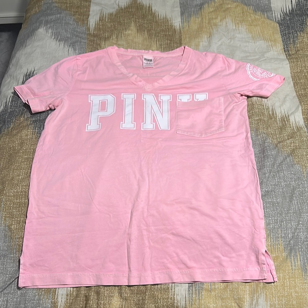Pink Shirt and it's in a size Medium